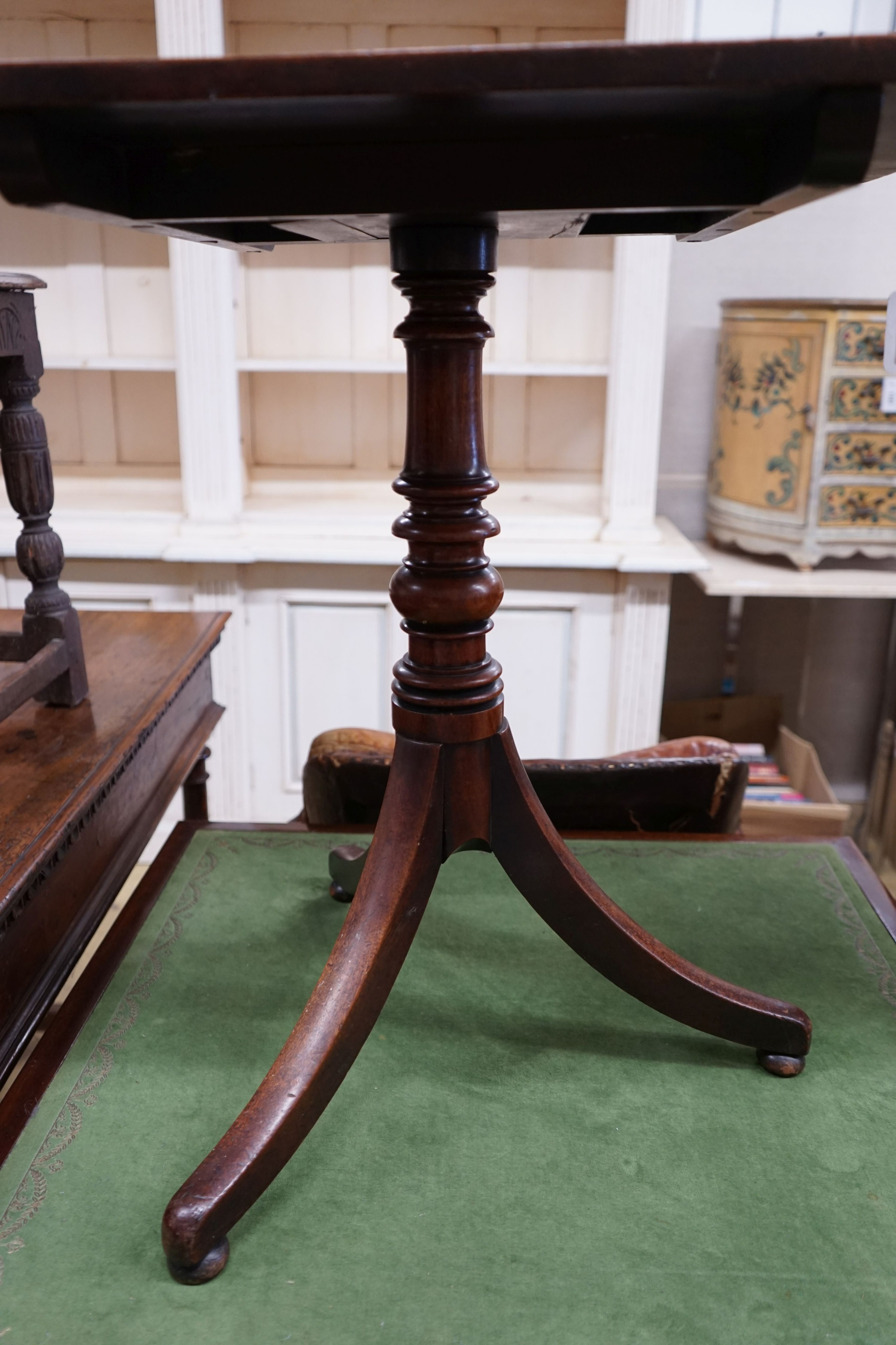 An early 19th century mahogany rectangular tilt top tripod table, width 64cm, depth 54cm, height 69cm